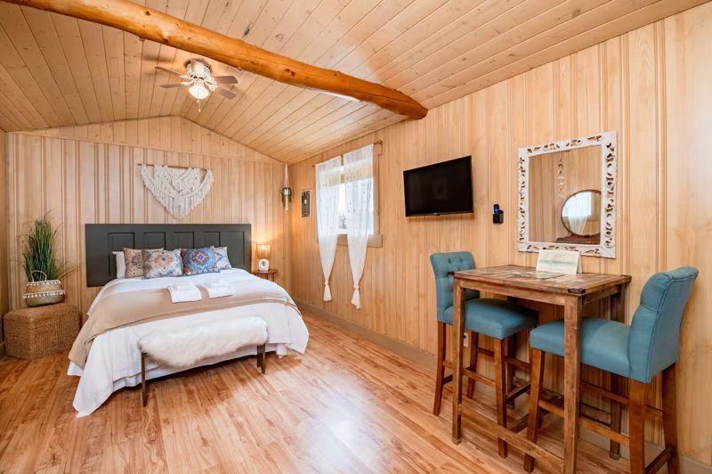 Inside Bohemian Escape — queen bed and bistro nook
