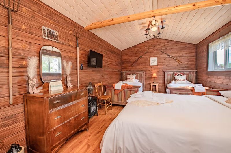 Inside The Bunkhouse — queen bed, two singles, western décor