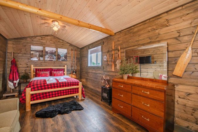 Inside The Lumberjack — plaid bedding and log bed frame