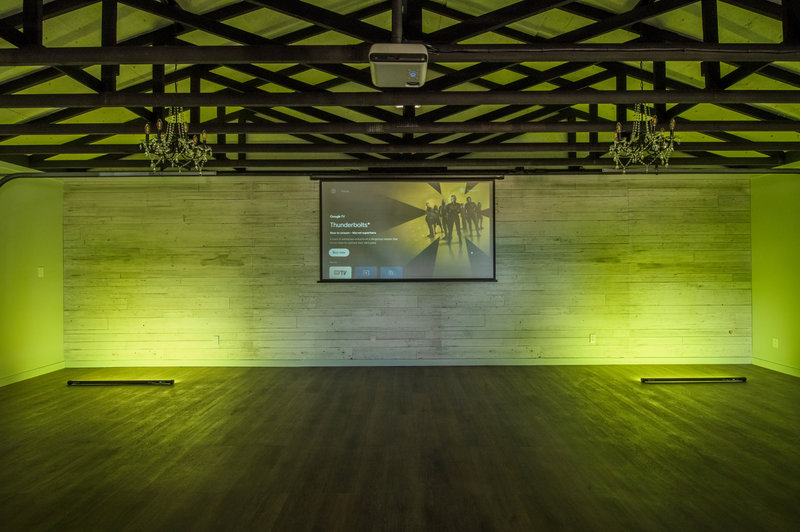 Inside the event hall with projector screen and chandelier lighting