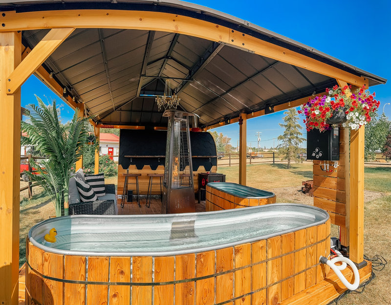 Wood-burning hillbilly hot tub rental delivered to a campsite