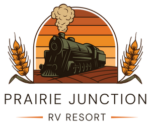 Prairie Junction RV Resort logo — steam train through a prairie sunset